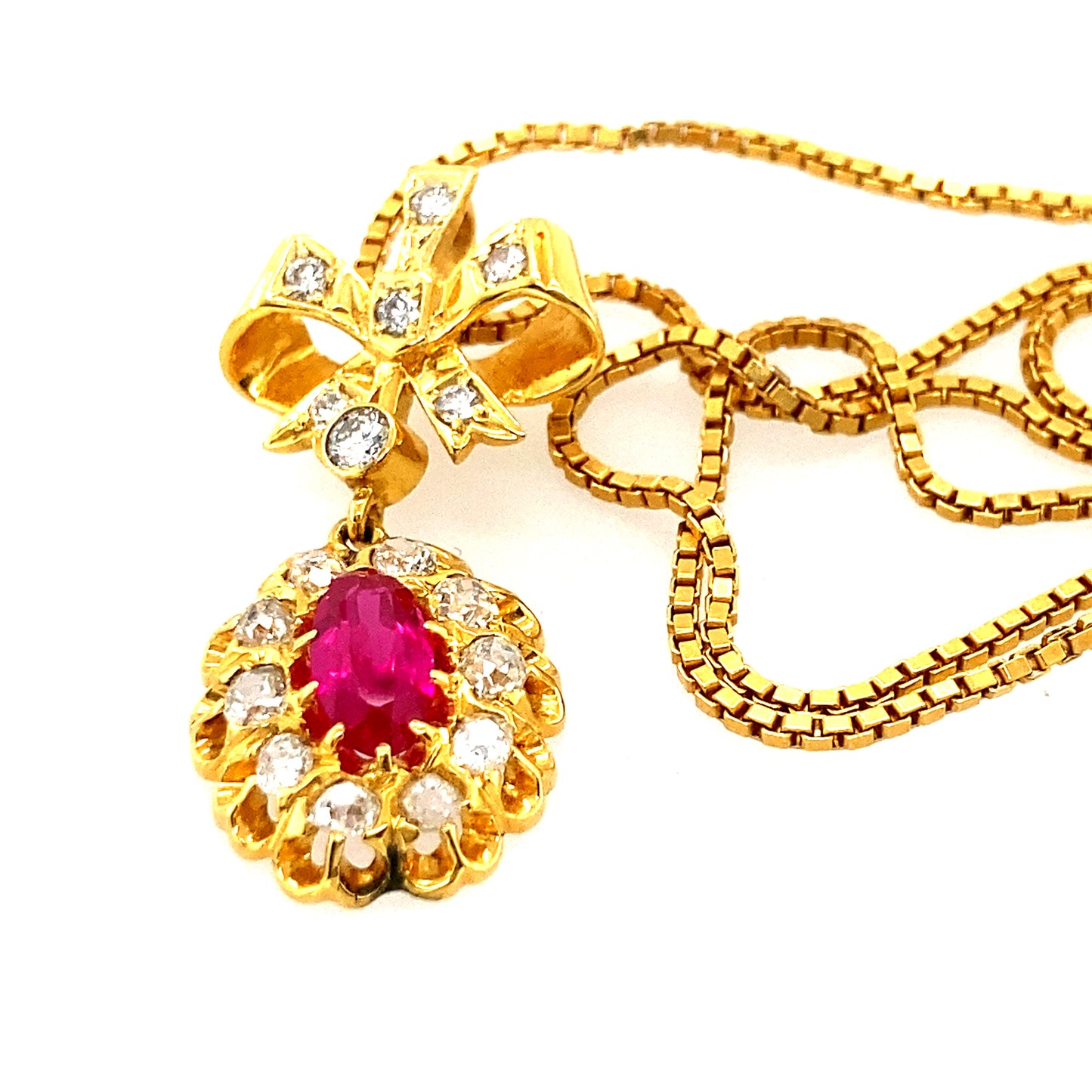 14k yellow gold chain with 14k Ruby Diamond pendant with pretty bow.