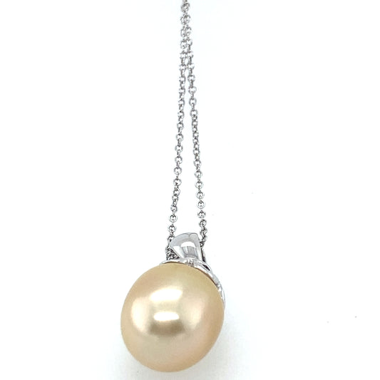 14k white gold yellow color south see pearl with small diamonds 14 mm. Chain is 14k white gold 26 inch.
