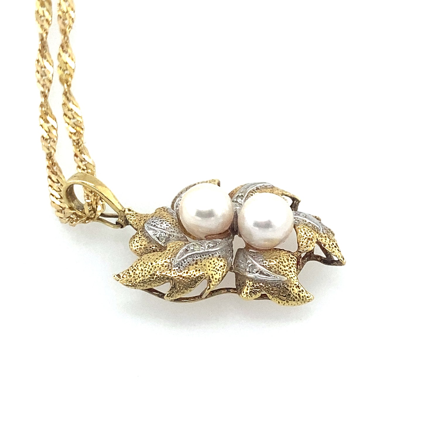 14k yellow and white gold pendant with 2 pc fresh water pearl. Chain is 14k yellow gold 20 inch.