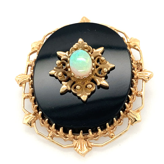 14 k yellow gold Onyx pendant. Middle of the pendant have a beautiful fire opal stone. Around the opal stone 14 k yellow gold frame look like stars. Very unique pice, art deco.