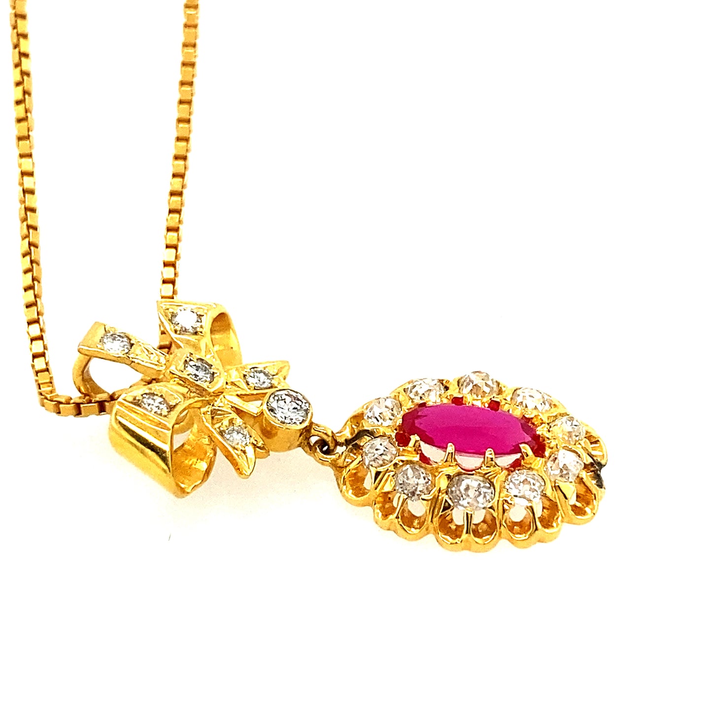 14k yellow gold chain with 14k Ruby Diamond pendant with pretty bow.