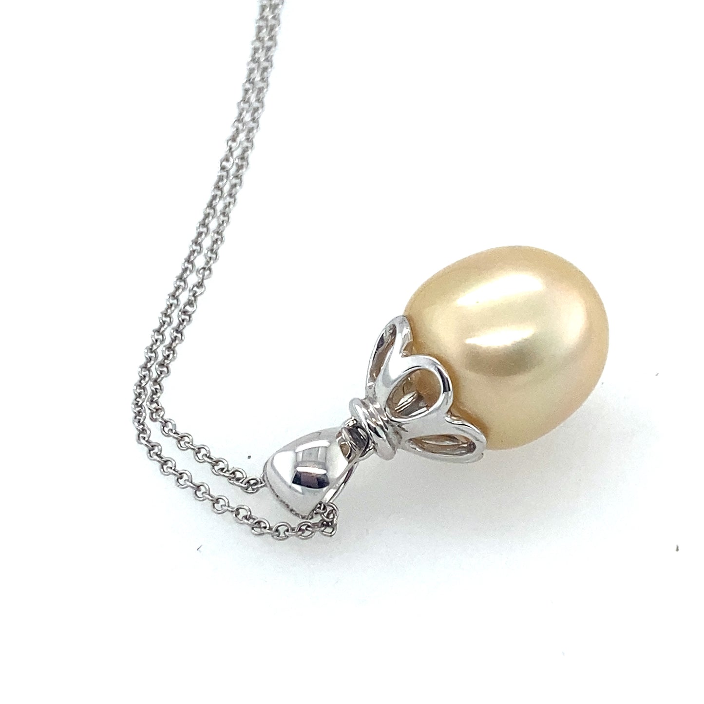 14k white gold yellow color south see pearl with small diamonds 14 mm. Chain is 14k white gold 26 inch.